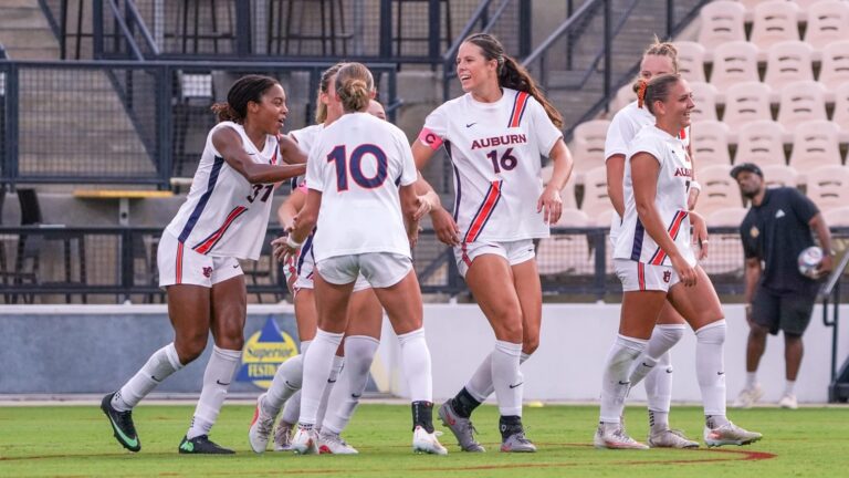 Auburn women's soccer players celebrate on the field