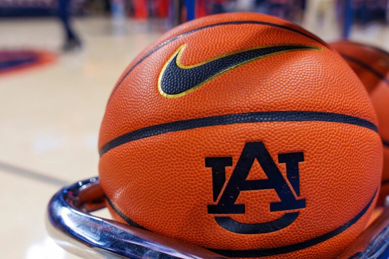 An Auburn basketball with the AU logo on a rack courtside